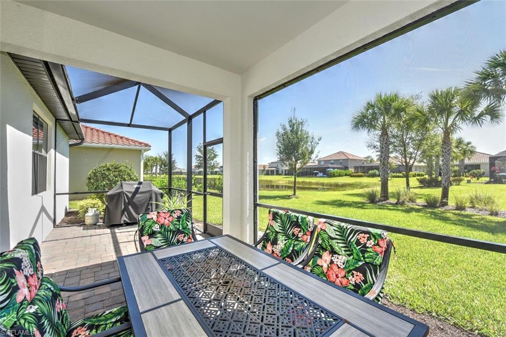 2106 Clementine Street Naples, FL 34120 - Photo 5 of 34 a view of a chairs and table in the balcony