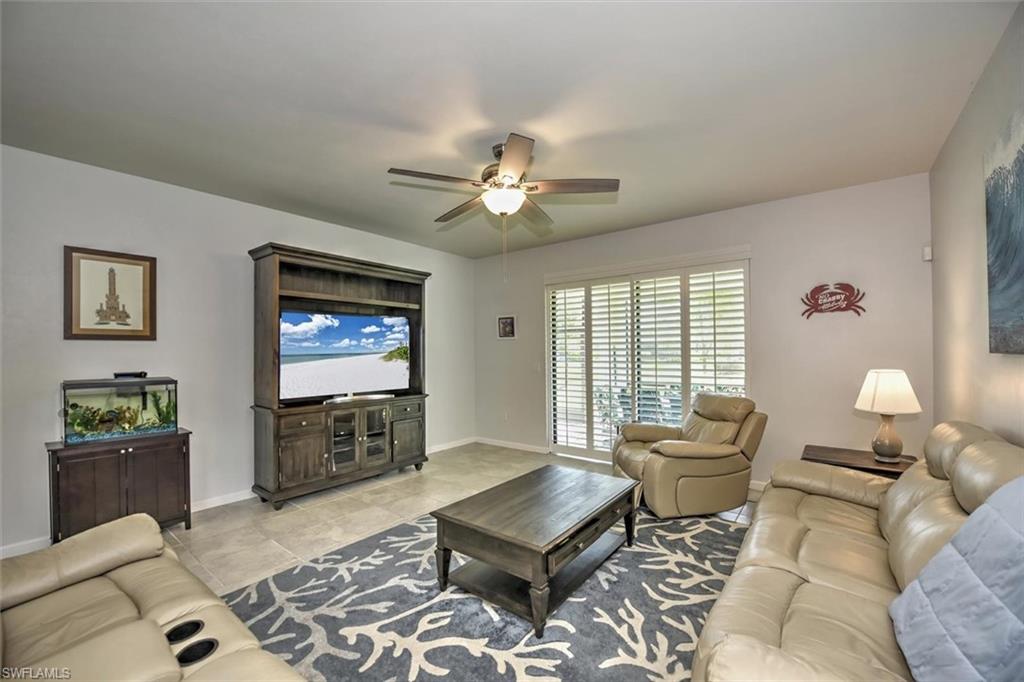 2106 Clementine Street Naples, FL 34120 - Photo 6 of 34 a living room with furniture and a flat screen tv