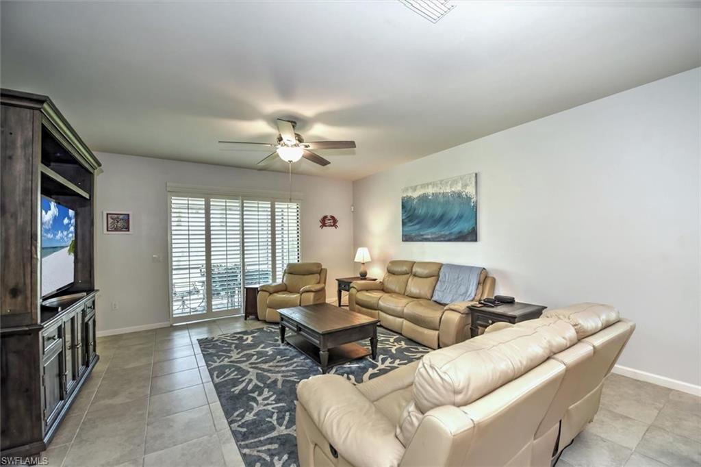 2106 Clementine Street Naples, FL 34120 - Photo 8 of 34 a living room with furniture and a flat screen tv