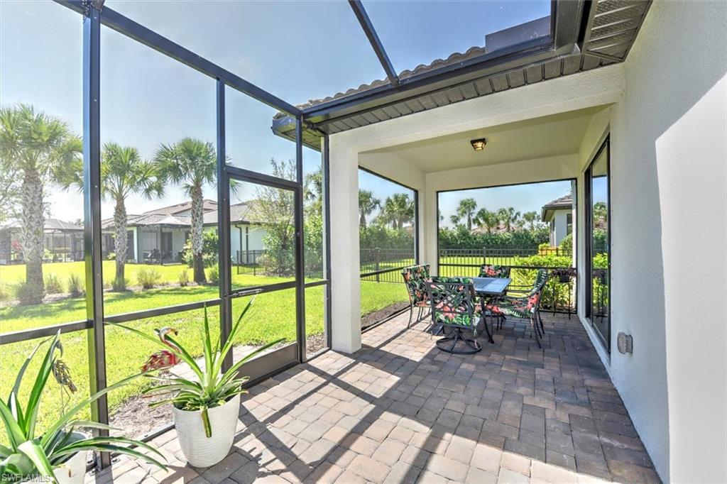 2106 Clementine Street Naples, FL 34120 - Photo 9 of 34 a view of a porch with furniture and floor to ceiling window