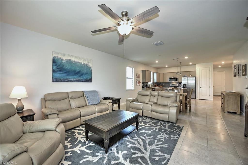 2106 Clementine Street Naples, FL 34120 - Photo 10 of 34 a living room with furniture kitchen view and a chandelier
