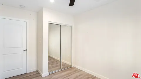 a room with wooden floor and entryway