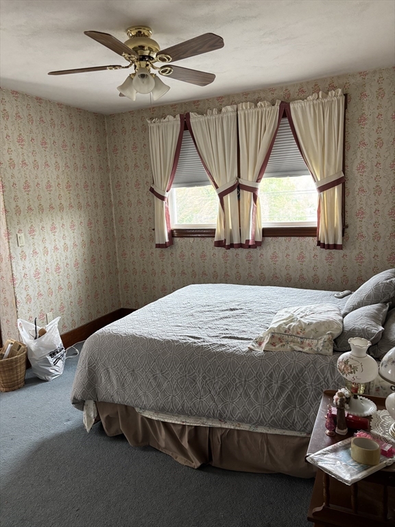 577 County Street Taunton, MA 02780 - Photo 9 of 23 a bedroom with a bed and a chandelier