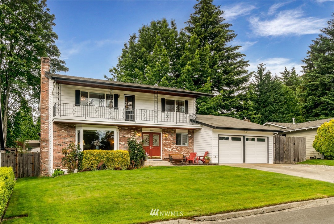 11812 Northeast 157th Street Bothell, WA 98011 - Photo 1 of 25 a front view of a house with a garden