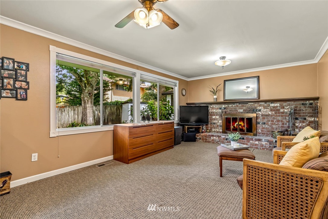 11812 Northeast 157th Street Bothell, WA 98011 - Photo 12 of 25 a living room with furniture and a fireplace