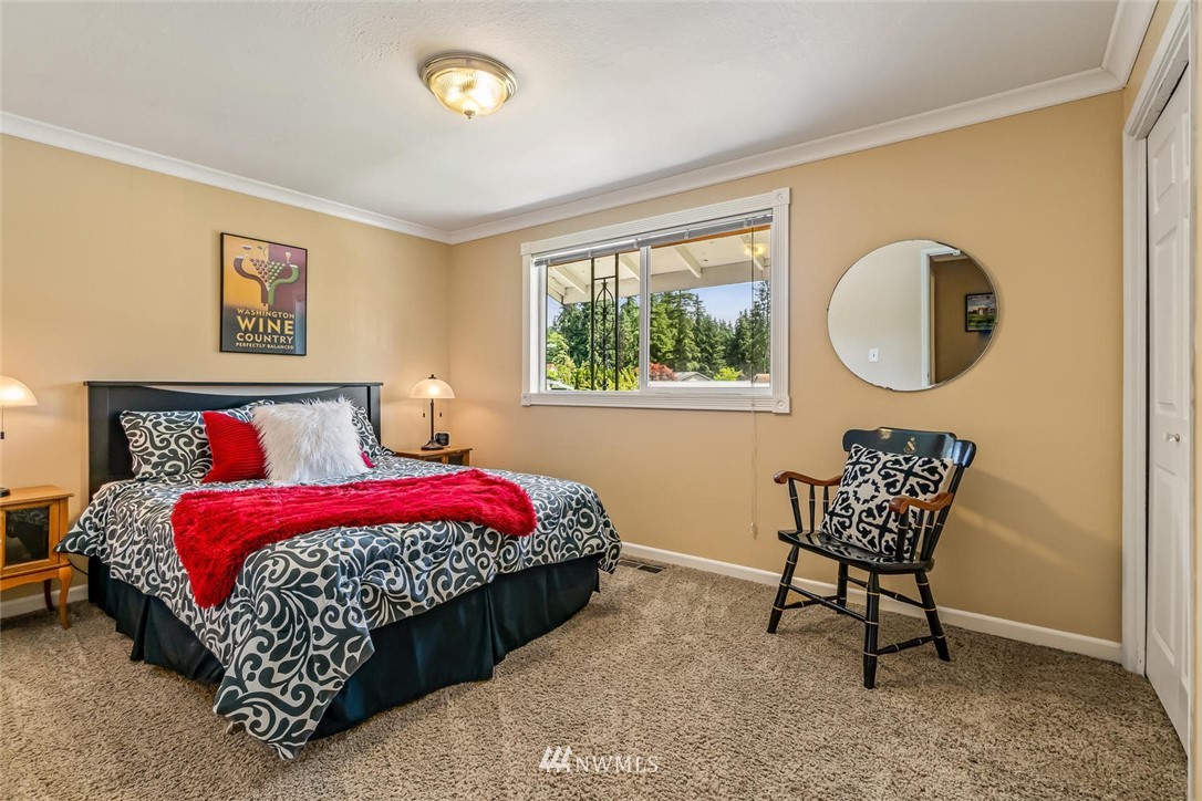 11812 Northeast 157th Street Bothell, WA 98011 - Photo 17 of 25 a bedroom with bed and a window