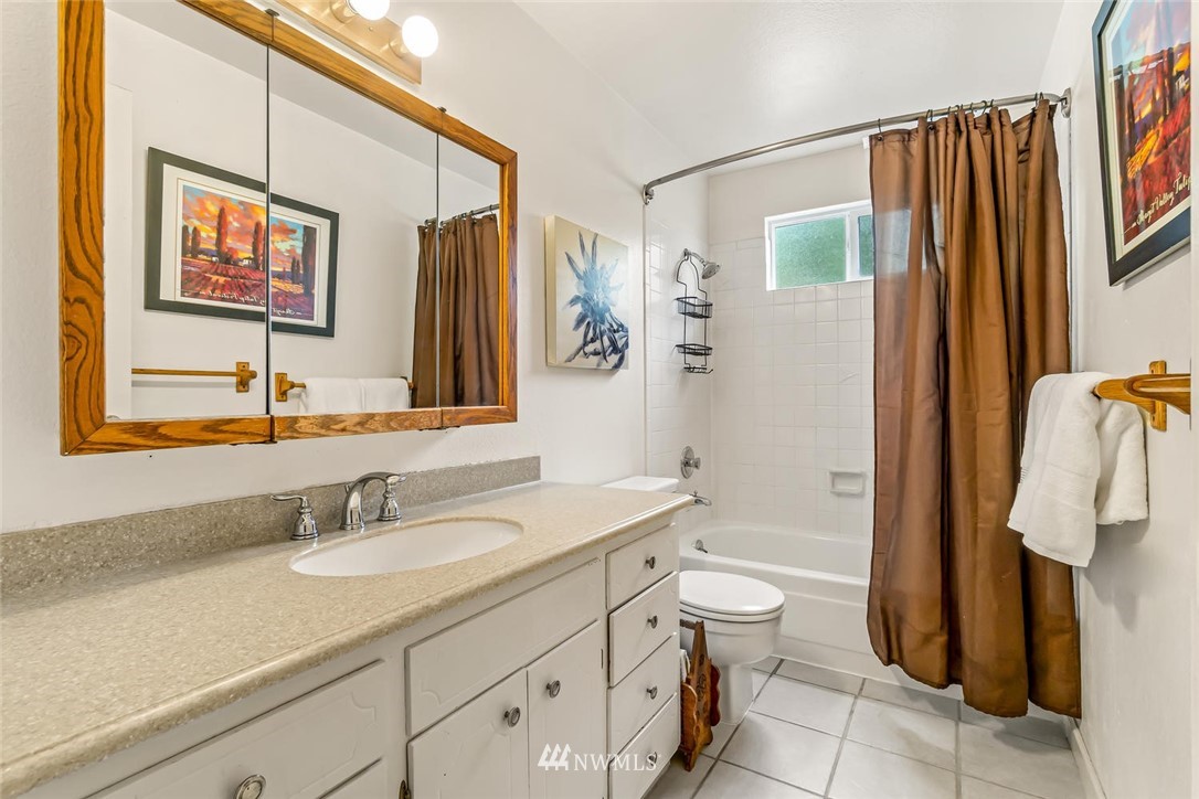 11812 Northeast 157th Street Bothell, WA 98011 - Photo 19 of 25 a bathroom with a sink a toilet and shower