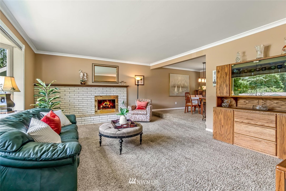 11812 Northeast 157th Street Bothell, WA 98011 - Photo 3 of 25 a living room with furniture and a fireplace