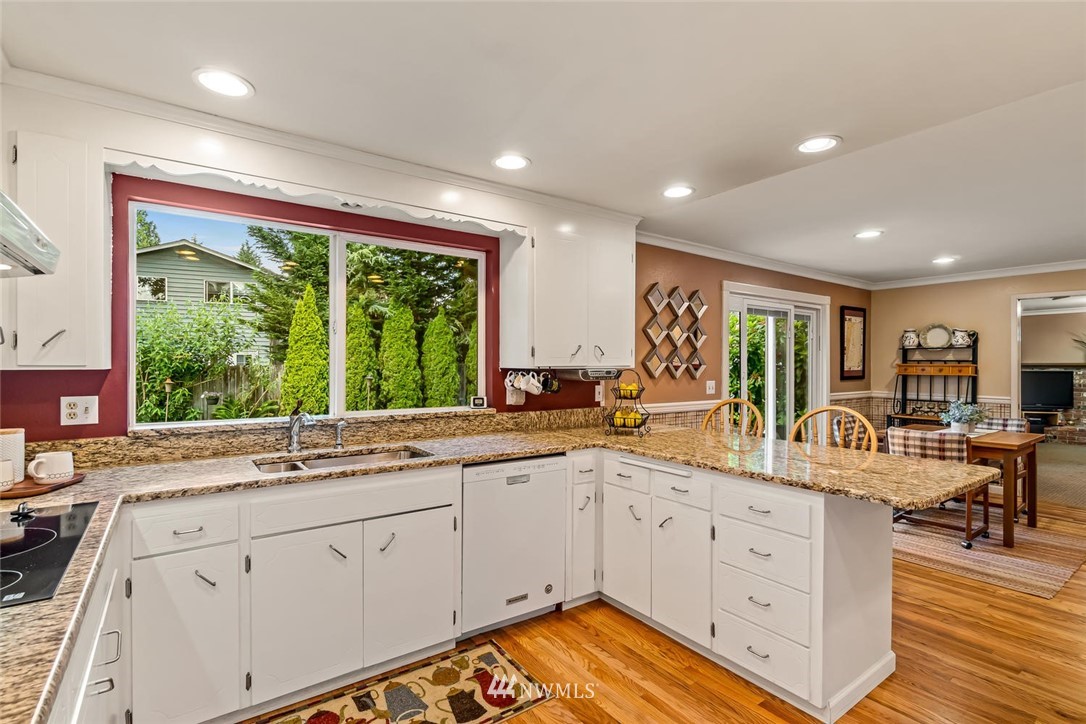 11812 Northeast 157th Street Bothell, WA 98011 - Photo 7 of 25 a large white kitchen with a large window