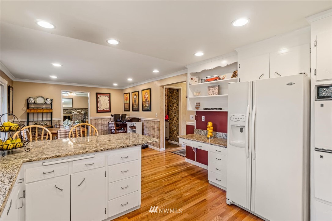 11812 Northeast 157th Street Bothell, WA 98011 - Photo 8 of 25 a kitchen with stainless steel appliances granite countertop a refrigerator and a sink