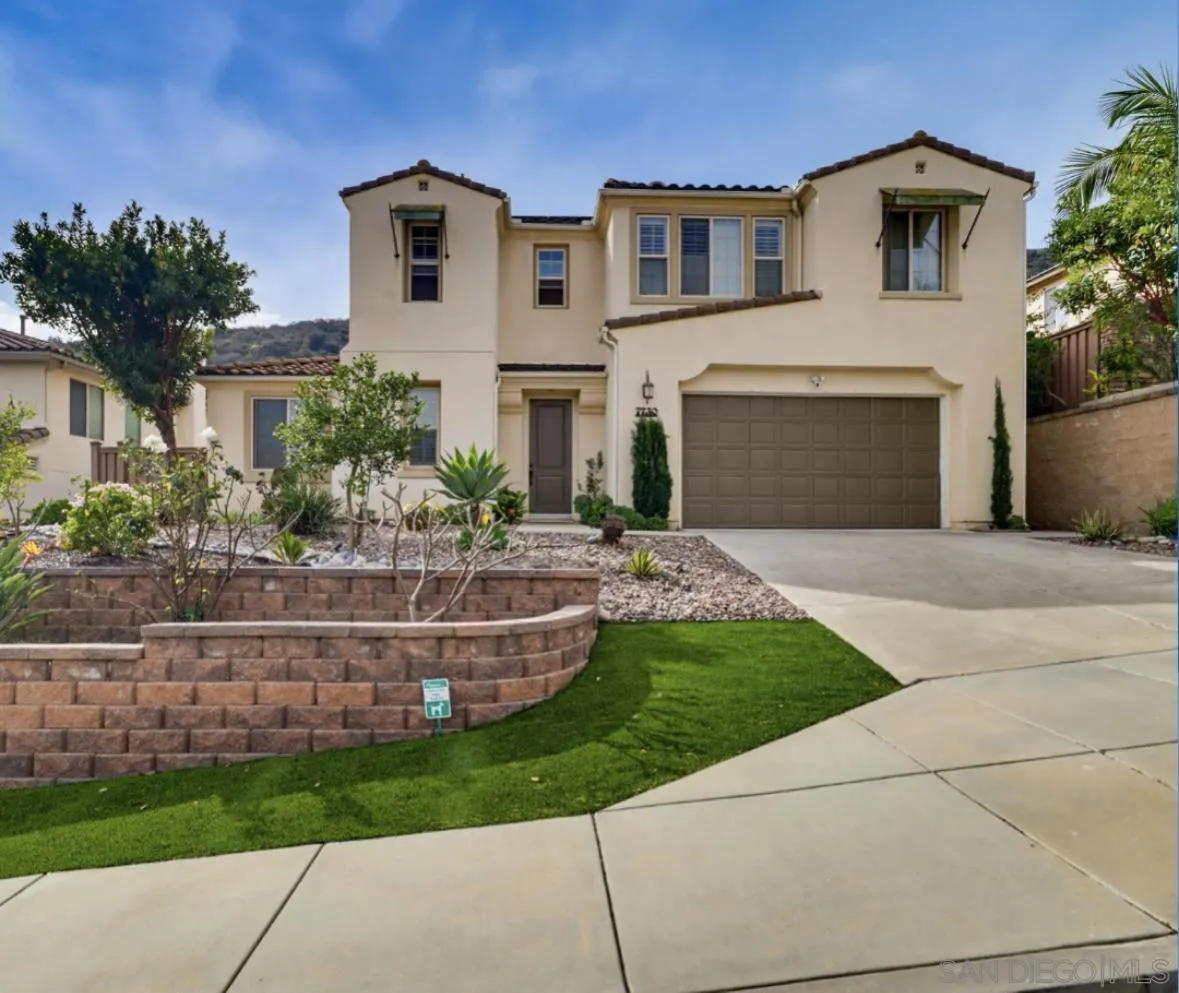 7730 Britt Place Santee, CA 92071 - Photo 1 of 1 a front view of a house with a yard and garage