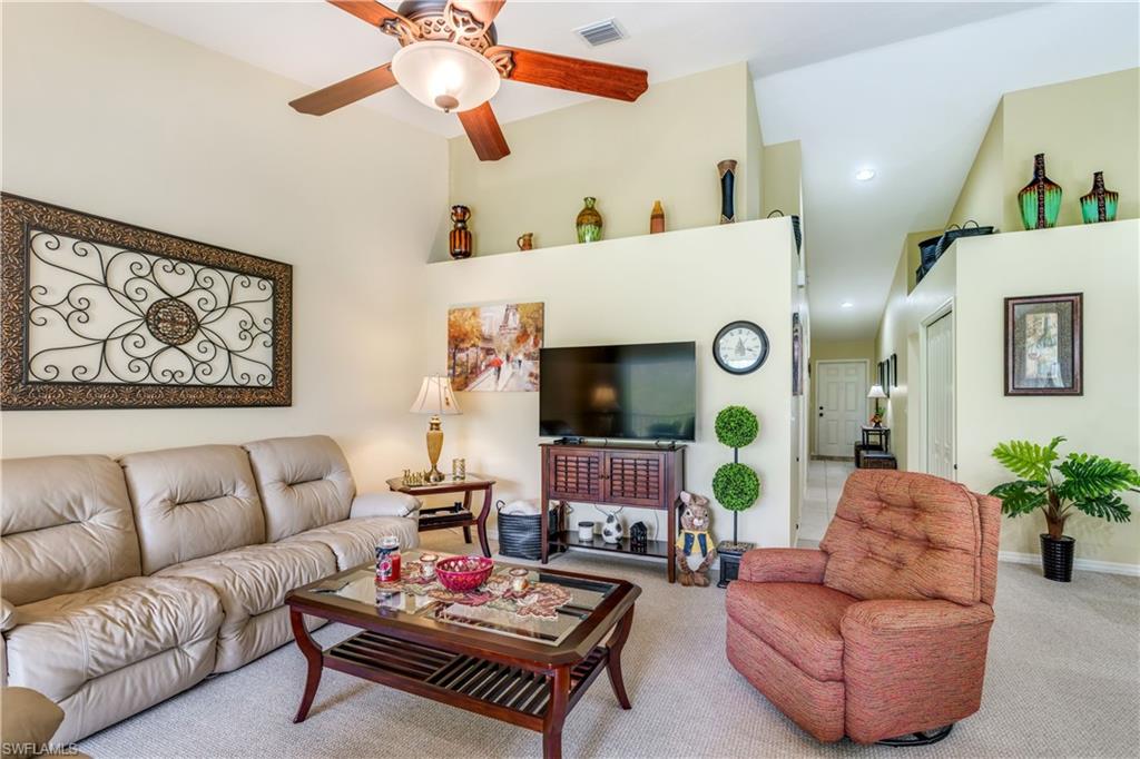 21341 Lancaster Run, Unit 425 Estero, FL 33928 - Photo 13 of 25 a living room with furniture and a flat screen tv