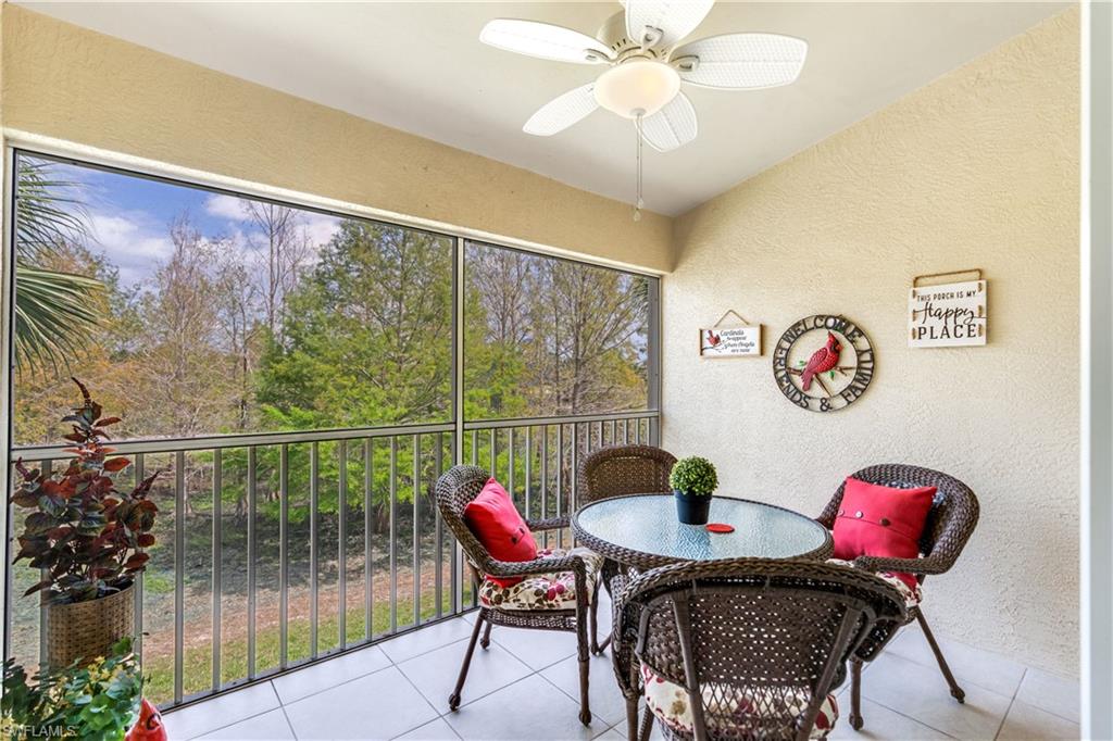 21341 Lancaster Run, Unit 425 Estero, FL 33928 - Photo 2 of 25 a view of a dining room with furniture and a floor to ceiling window