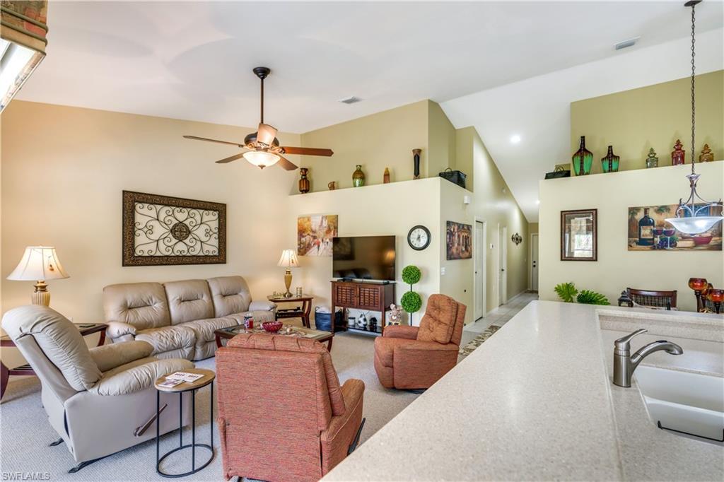 21341 Lancaster Run, Unit 425 Estero, FL 33928 - Photo 5 of 25 a living room with furniture and a chandelier