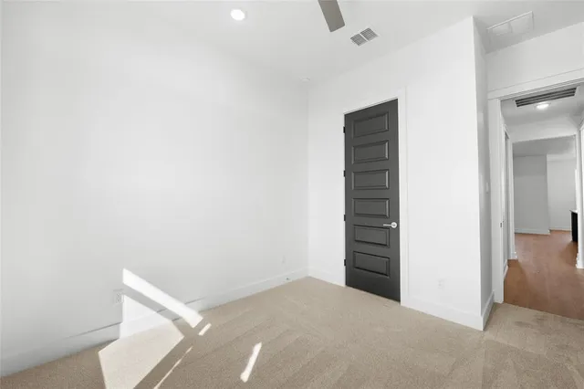 an empty room with a hallway and stairs