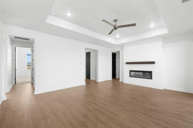 a large kitchen with stainless steel appliances a large counter top a sink a stove and a refrigerator