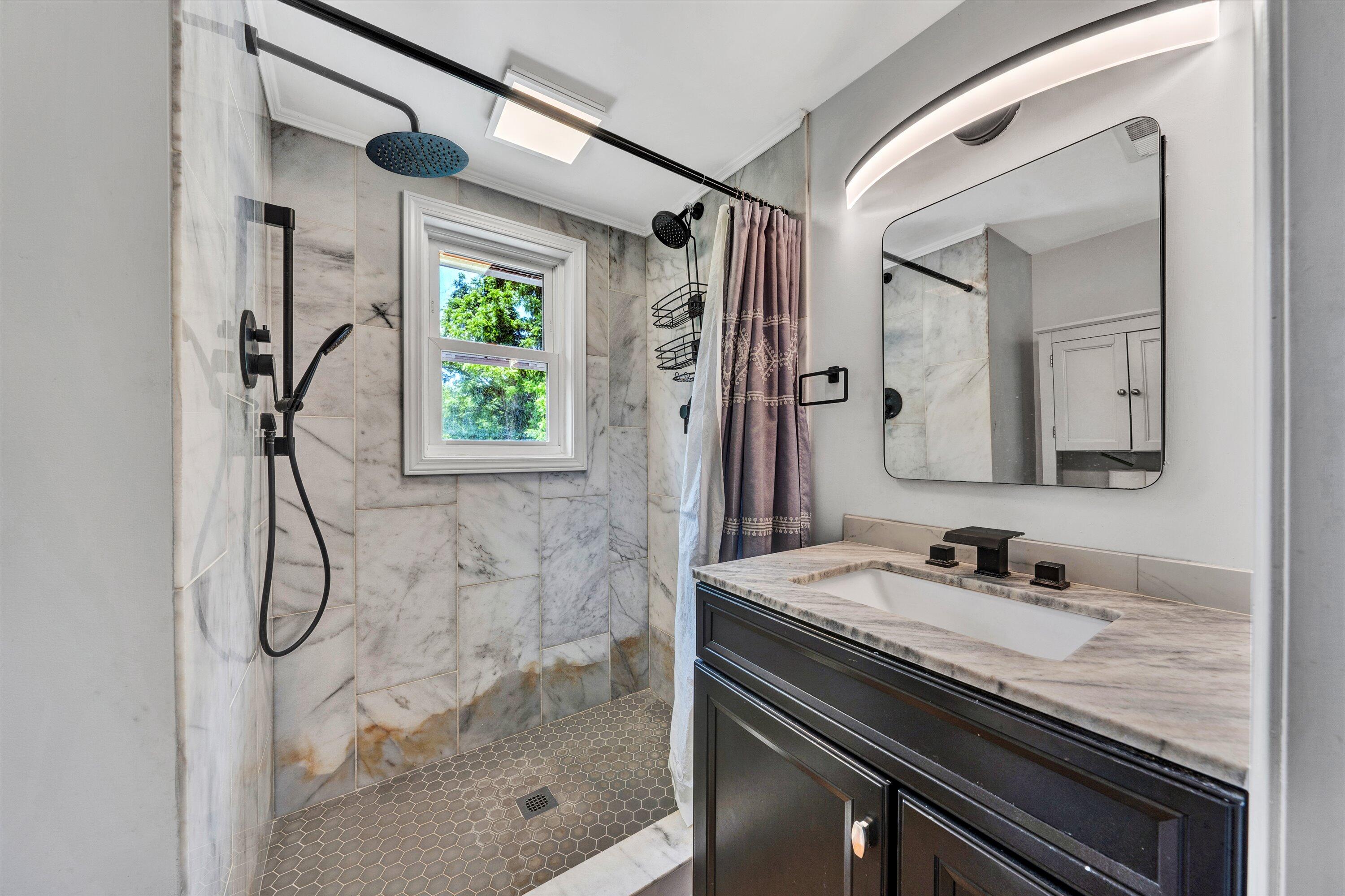 1200 Rock Spring Road Goodview, VA 24095 - Photo 16 of 31 a bathroom with a granite countertop sink a mirror and shower