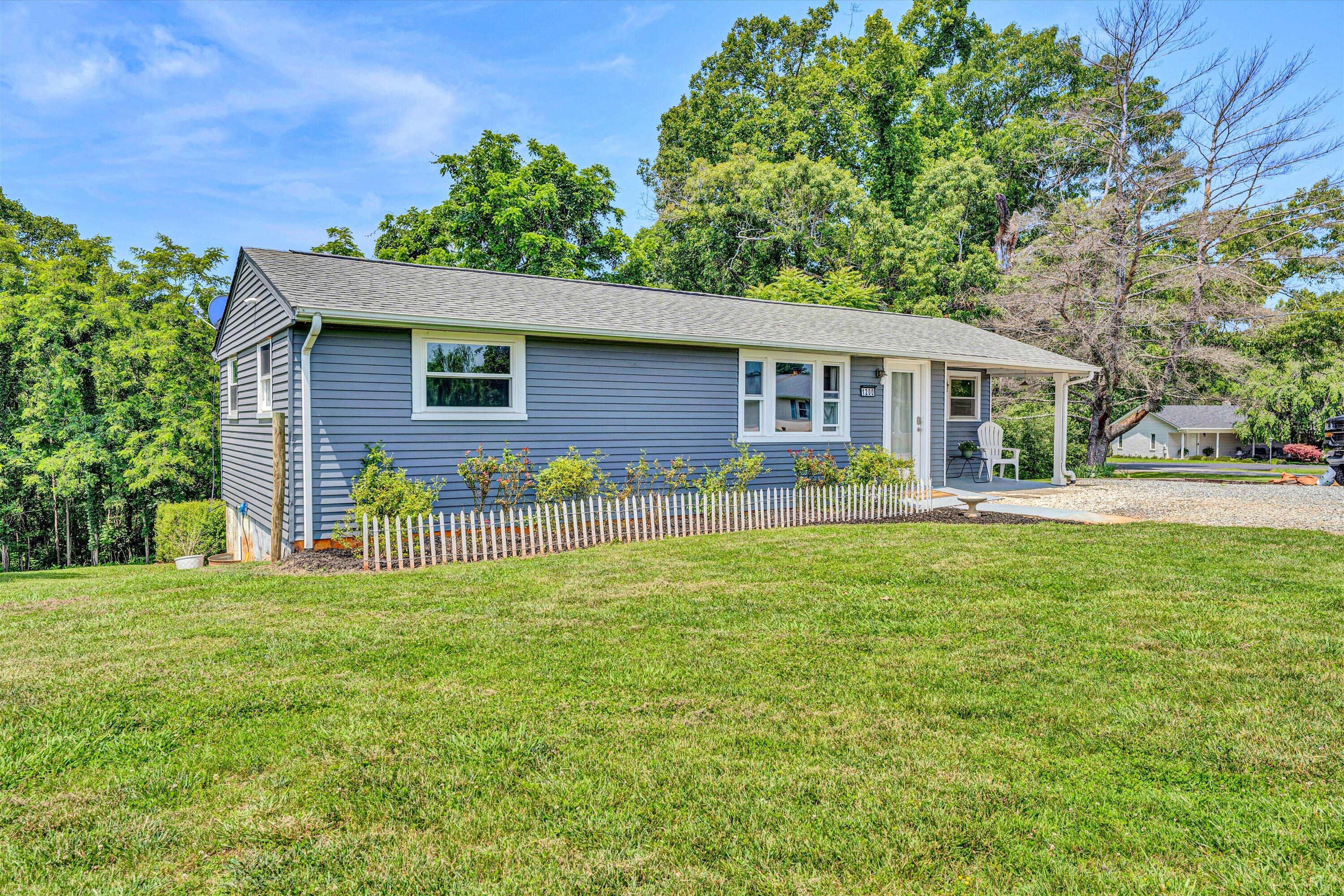 1200 Rock Spring Road Goodview, VA 24095 - Photo 2 of 31 a front view of a house with a garden