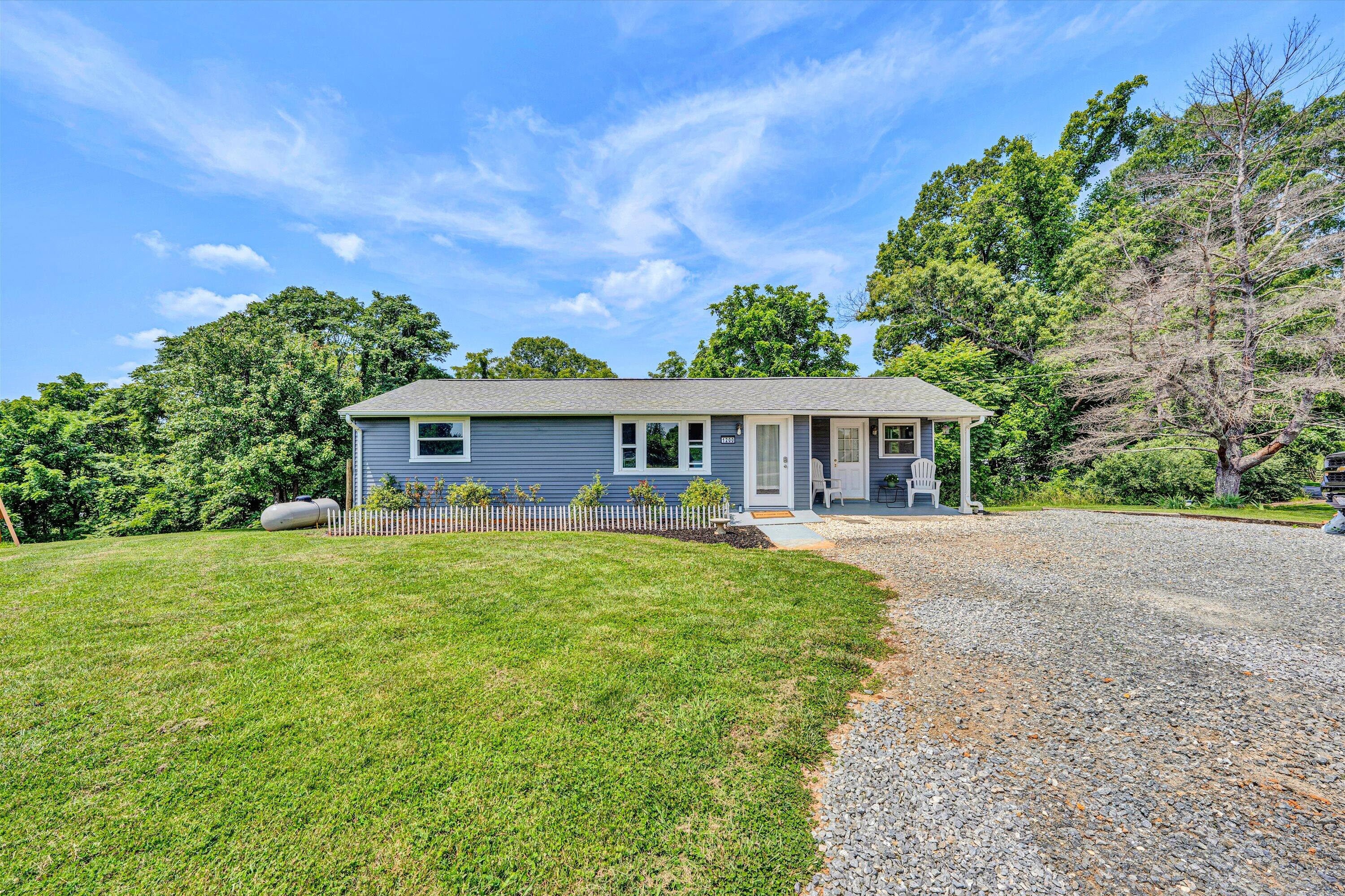 1200 Rock Spring Road Goodview, VA 24095 - Photo 23 of 31 a front view of a house with a garden