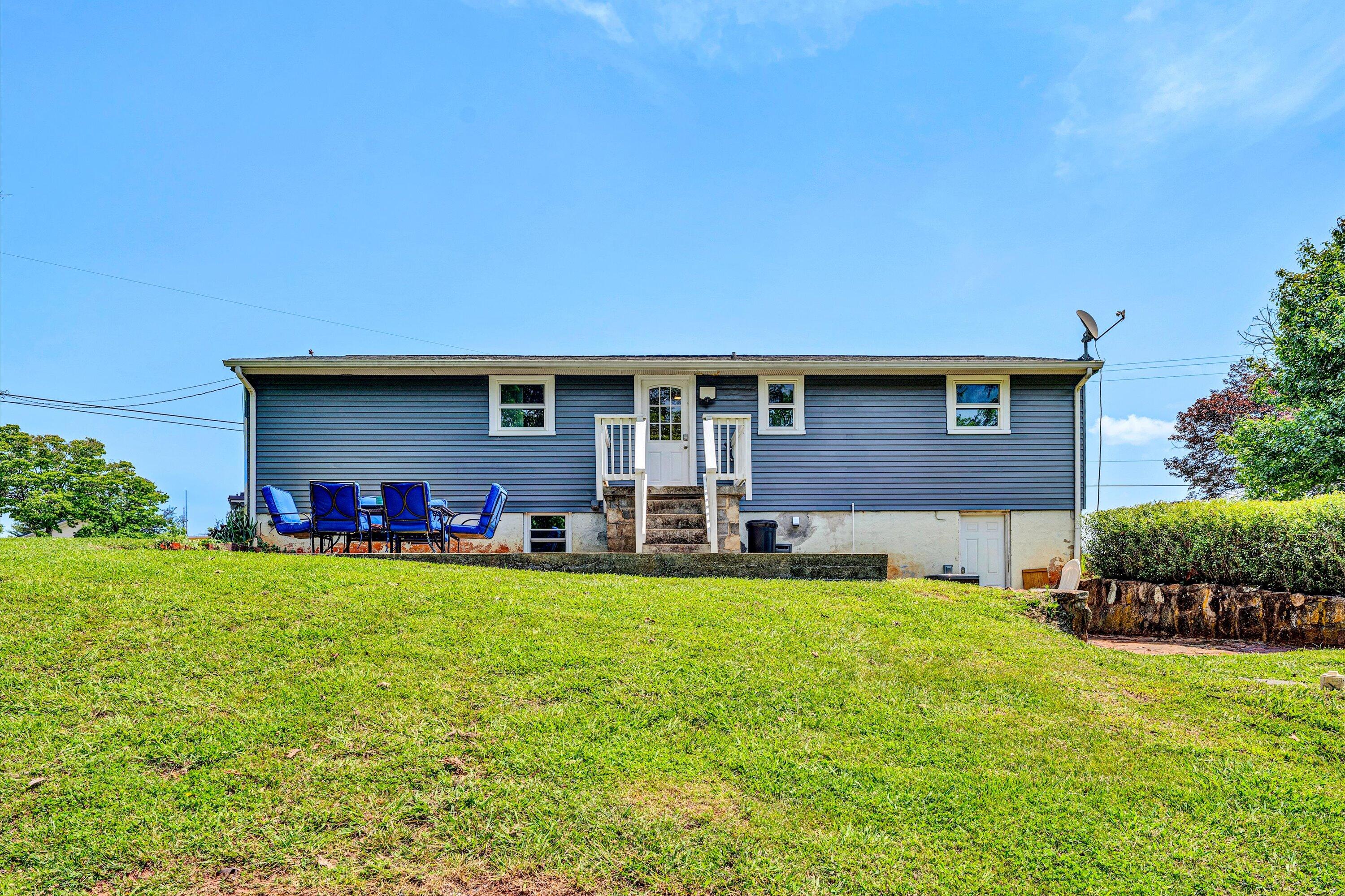 1200 Rock Spring Road Goodview, VA 24095 - Photo 24 of 31 a front view of a house with a garden