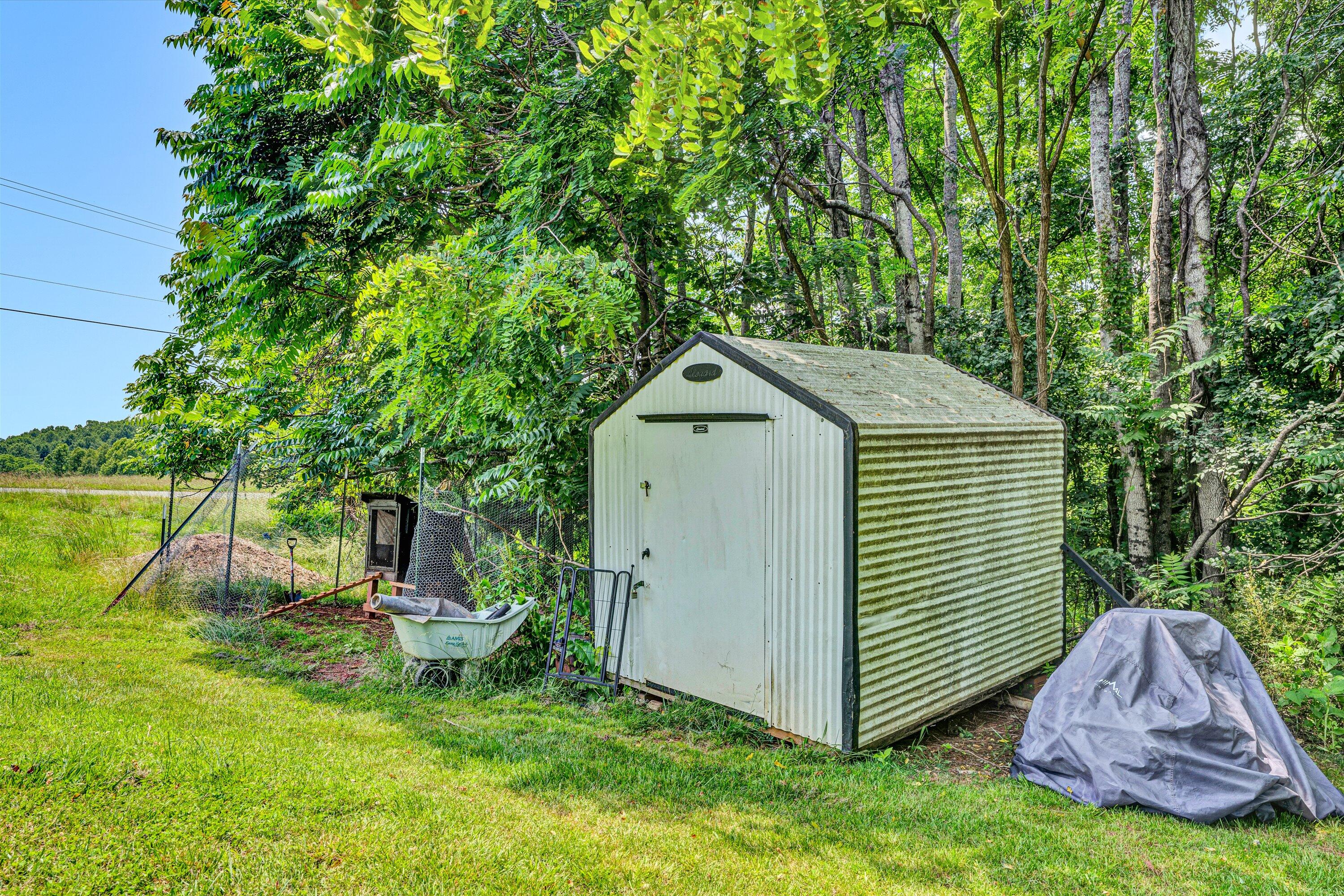 1200 Rock Spring Road Goodview, VA 24095 - Photo 29 of 31 a view of a backyard with a small cabin