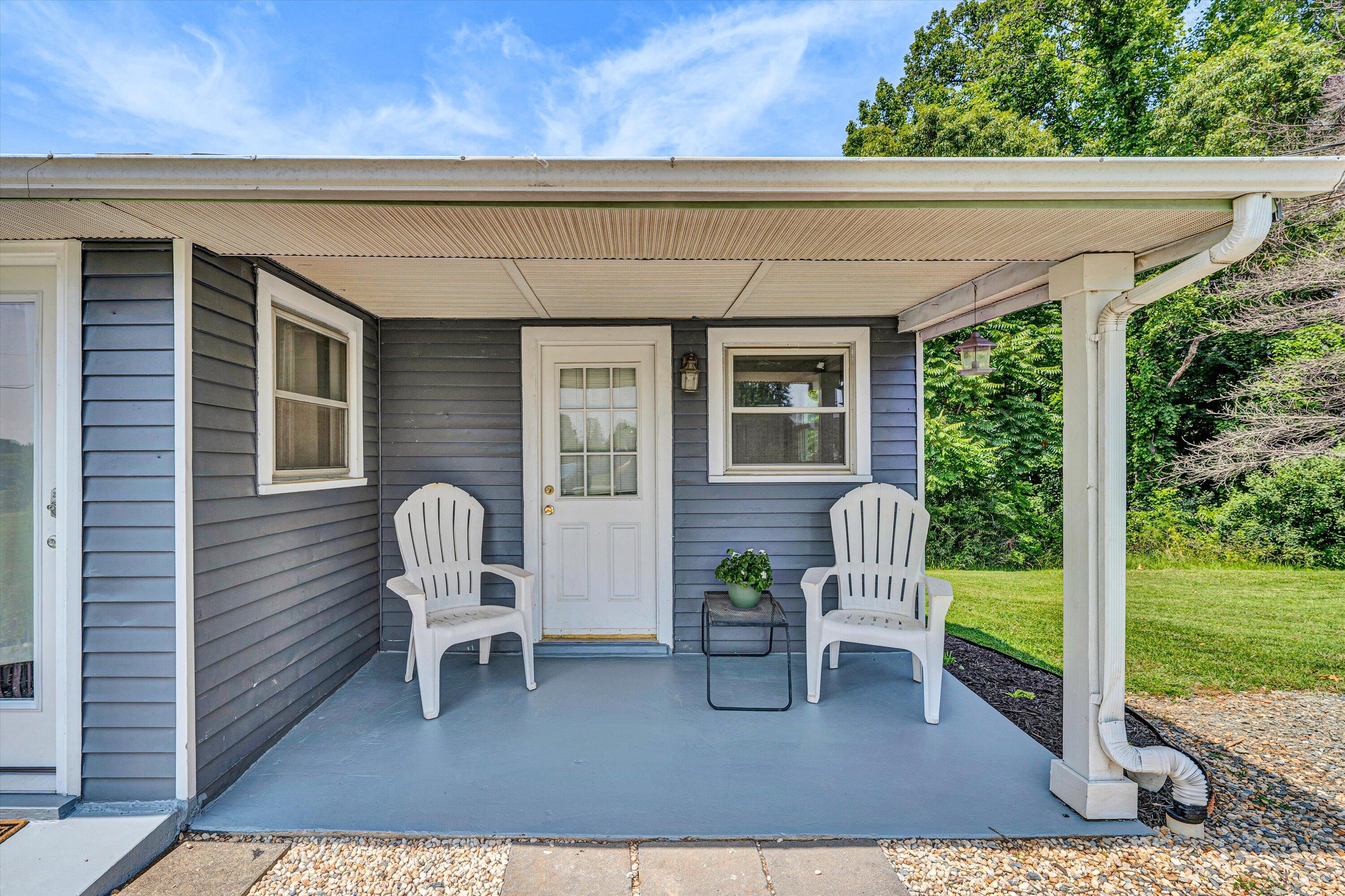 1200 Rock Spring Road Goodview, VA 24095 - Photo 4 of 31 a view of a patio with a table chairs and a potted plant