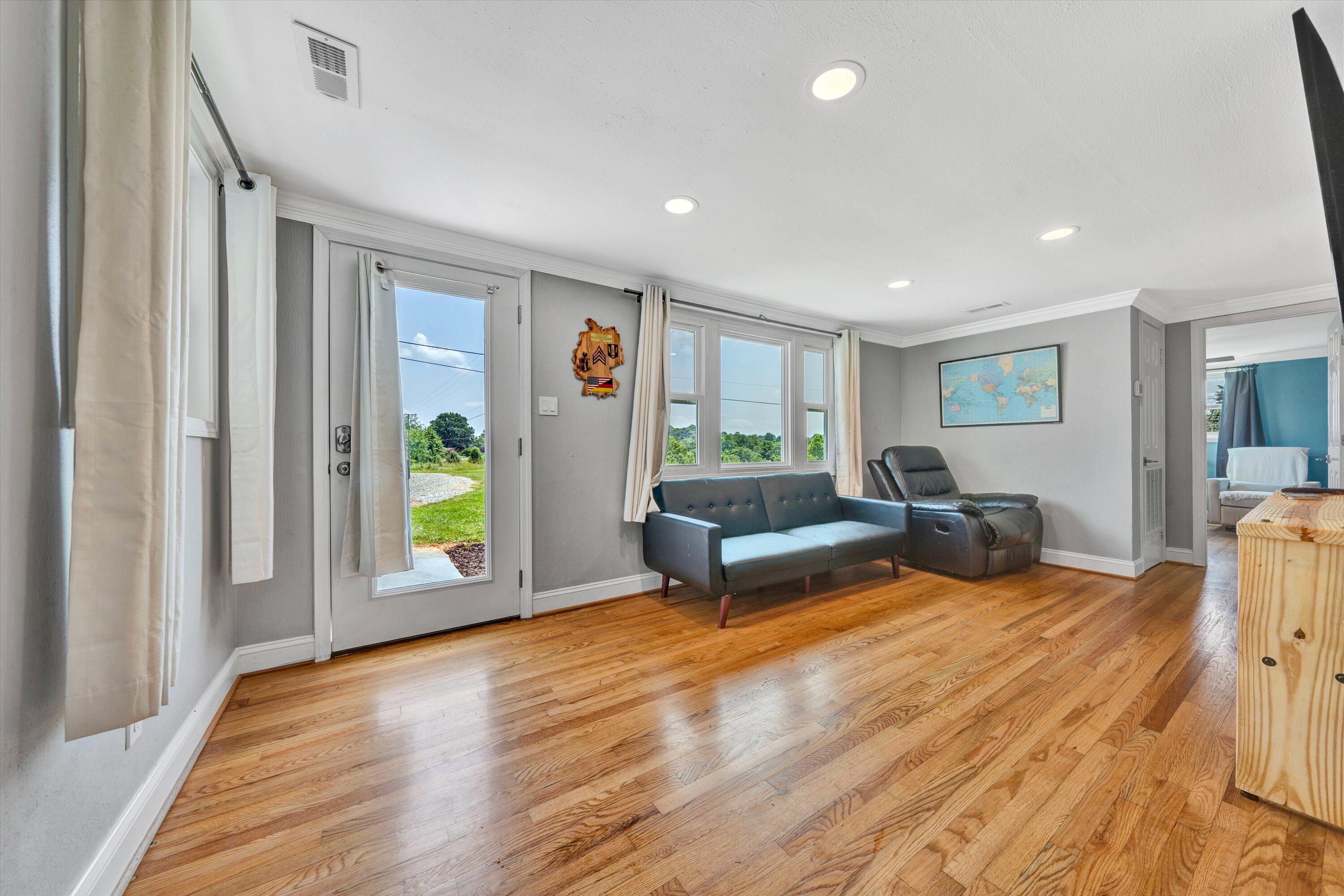 1200 Rock Spring Road Goodview, VA 24095 - Photo 5 of 31 a living room with furniture and a wooden floor