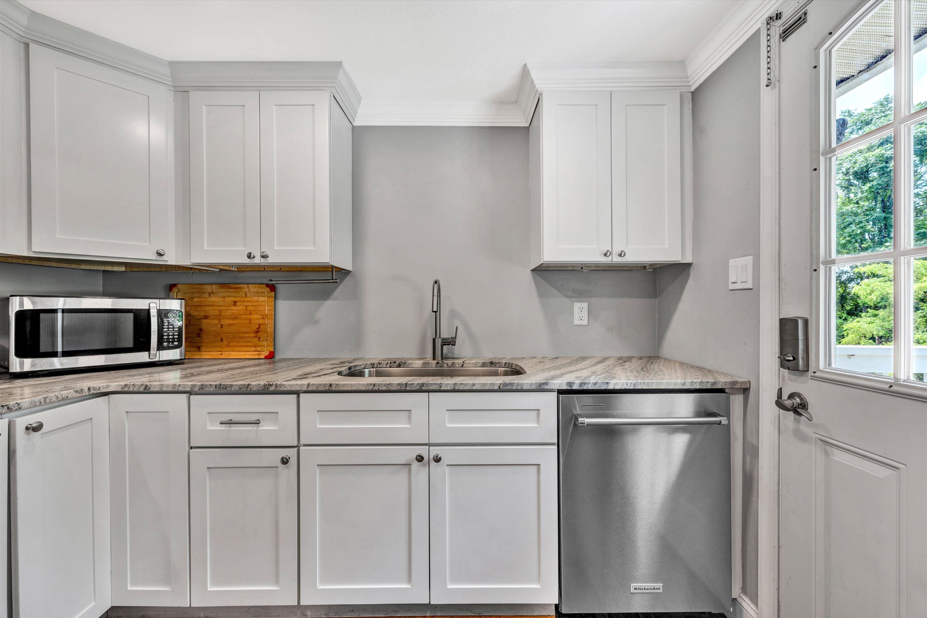 1200 Rock Spring Road Goodview, VA 24095 - Photo 10 of 31 a kitchen with white cabinets and white appliances
