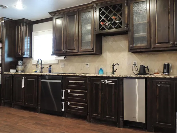 a kitchen with stainless steel appliances granite countertop a refrigerator and a sink