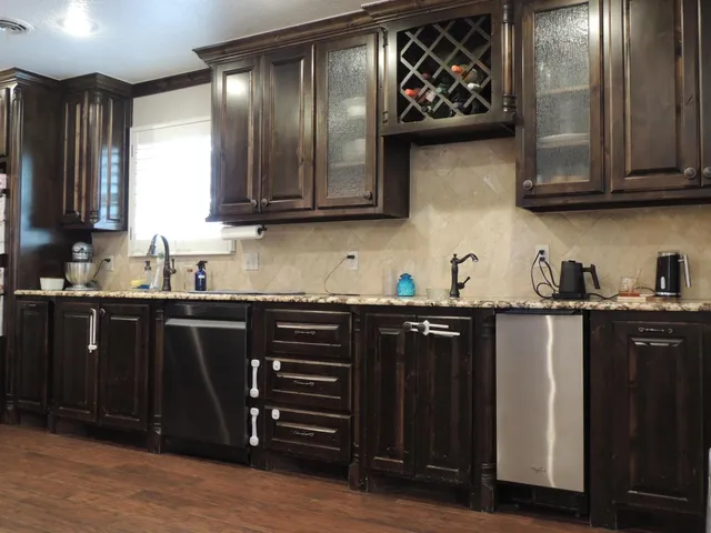 a kitchen with stainless steel appliances granite countertop a refrigerator and a sink