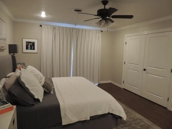 a bedroom with a bed and a chandelier