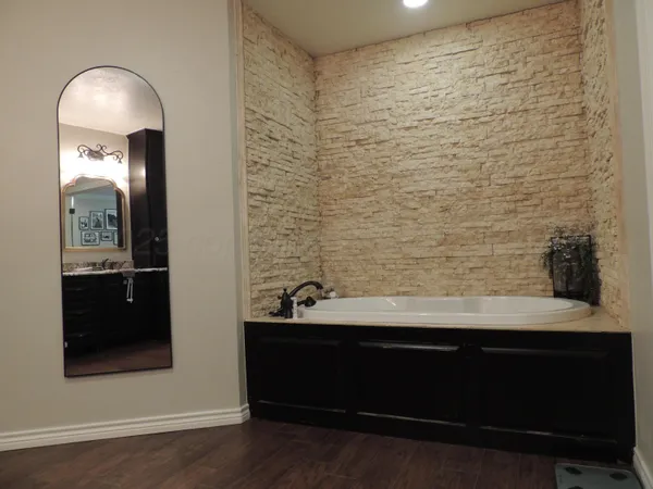 a view of bathroom with mirror and shower