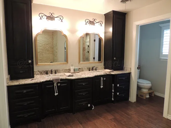 a spacious bathroom with a double vanity sink and a mirror