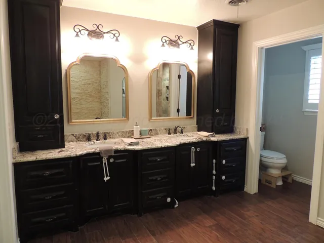 a spacious bathroom with a double vanity sink and a mirror