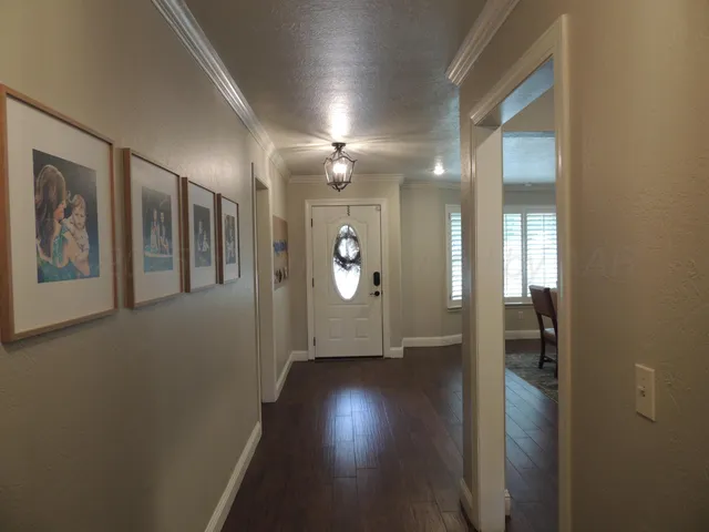 a view of hallway with wooden floor