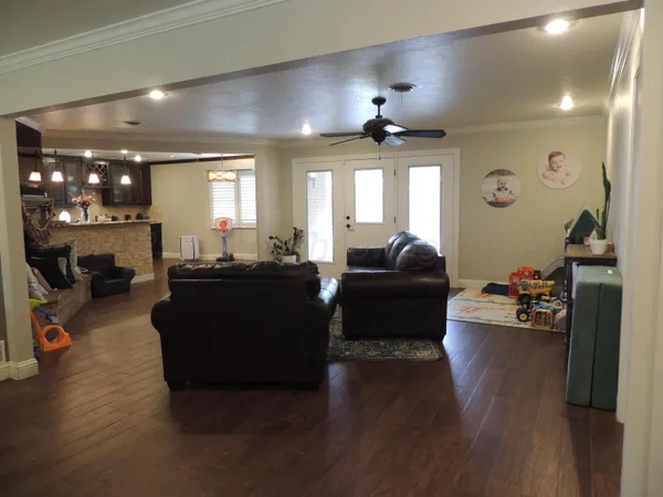 a living room with furniture and wooden floor