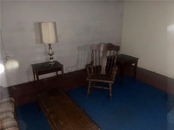 a view of a workspace with furniture and wooden floor