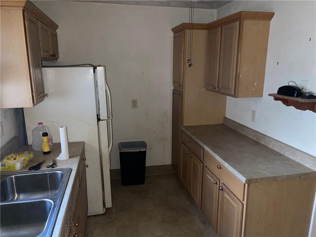 38 3rd Street Scottdale, PA 15683 - Photo 7 of 17 a kitchen with stainless steel appliances a refrigerator and a stove