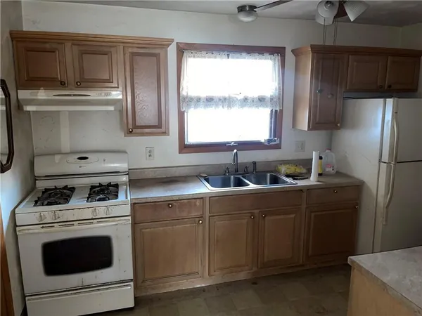 a kitchen with a sink stove and refrigerator