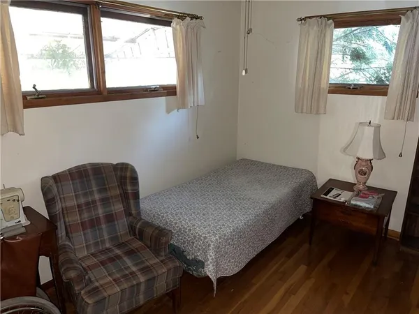 a bedroom with a bed and windows