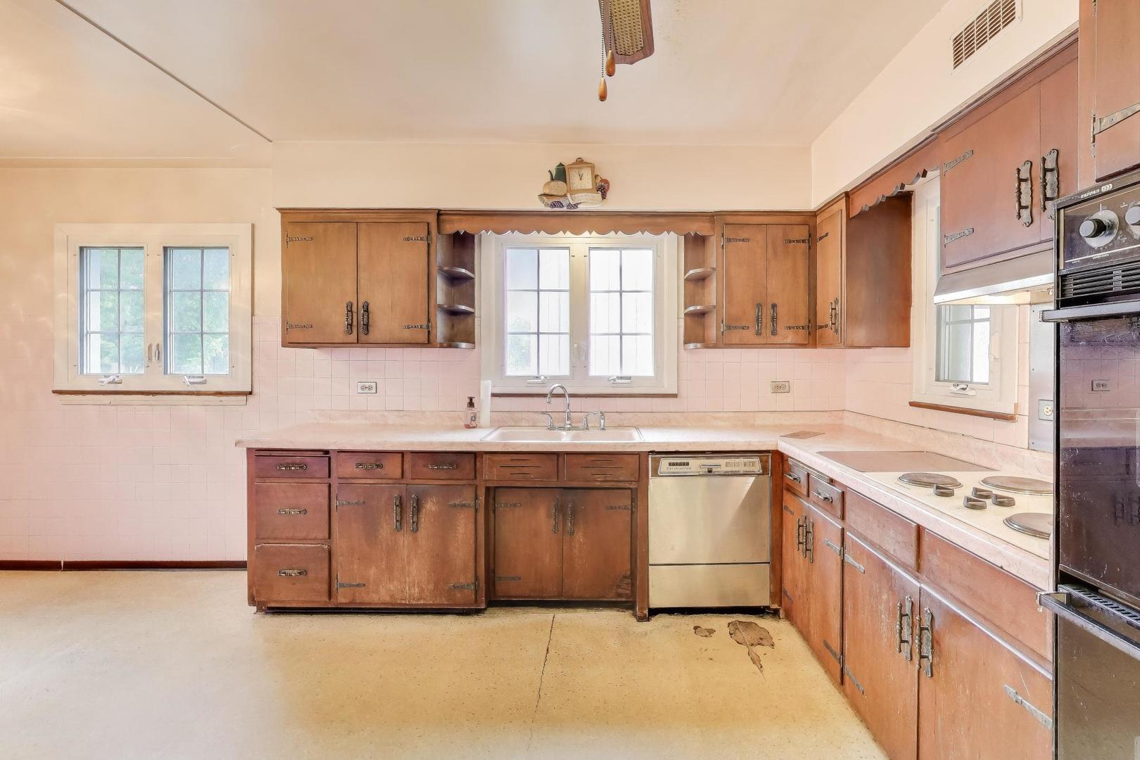 601 Selborne Road Riverside, IL 60546 - Photo 10 of 56 a kitchen with stainless steel appliances granite countertop a stove a sink and a microwave
