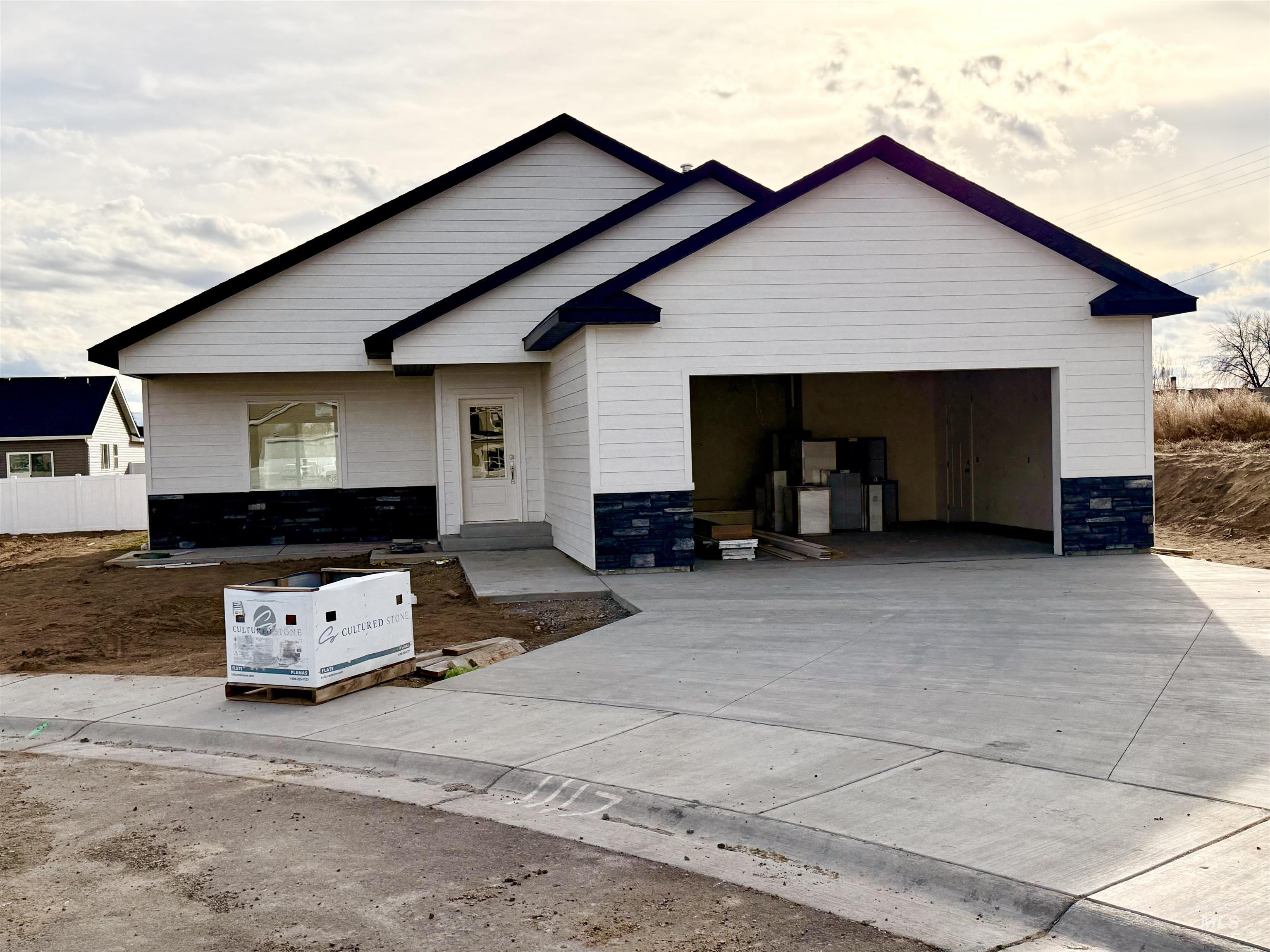 View of front of house with driveway and an attached garage