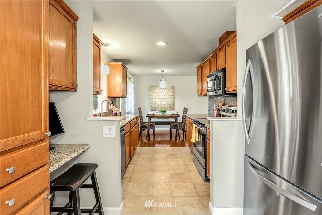 22703 2nd Place West Bothell, WA 98021 - Photo 13 of 23 a kitchen with stainless steel appliances a refrigerator and a stove top oven
