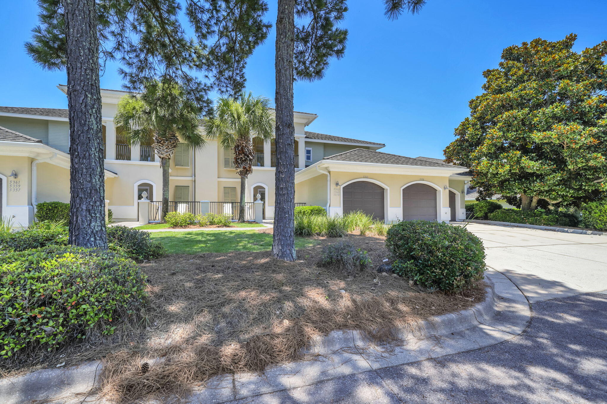 5360 Pine Ridge Lane, Unit 5360 Miramar Beach, FL 32550 - Photo 1 of 44 a view of a white house with a yard and large tree