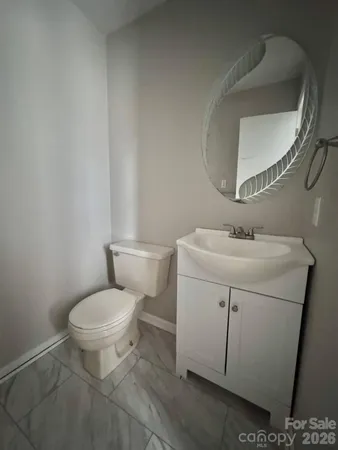 a white toilet sitting next to a bathroom sink