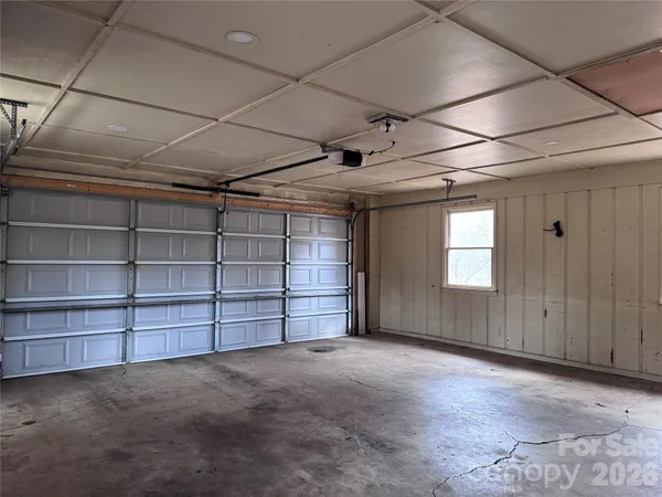 a view of an empty room with a cabinet and storage