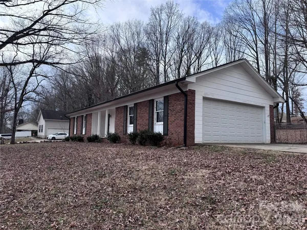 a house that has a tree in front of it