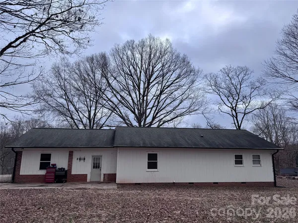 a view of house with backyard