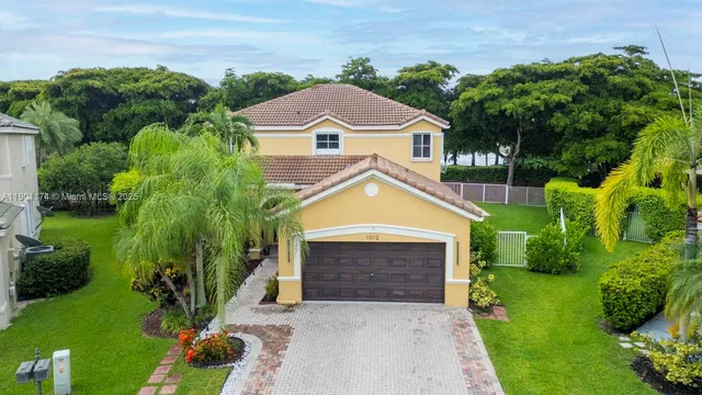 a aerial view of a house with a yard and potted plants