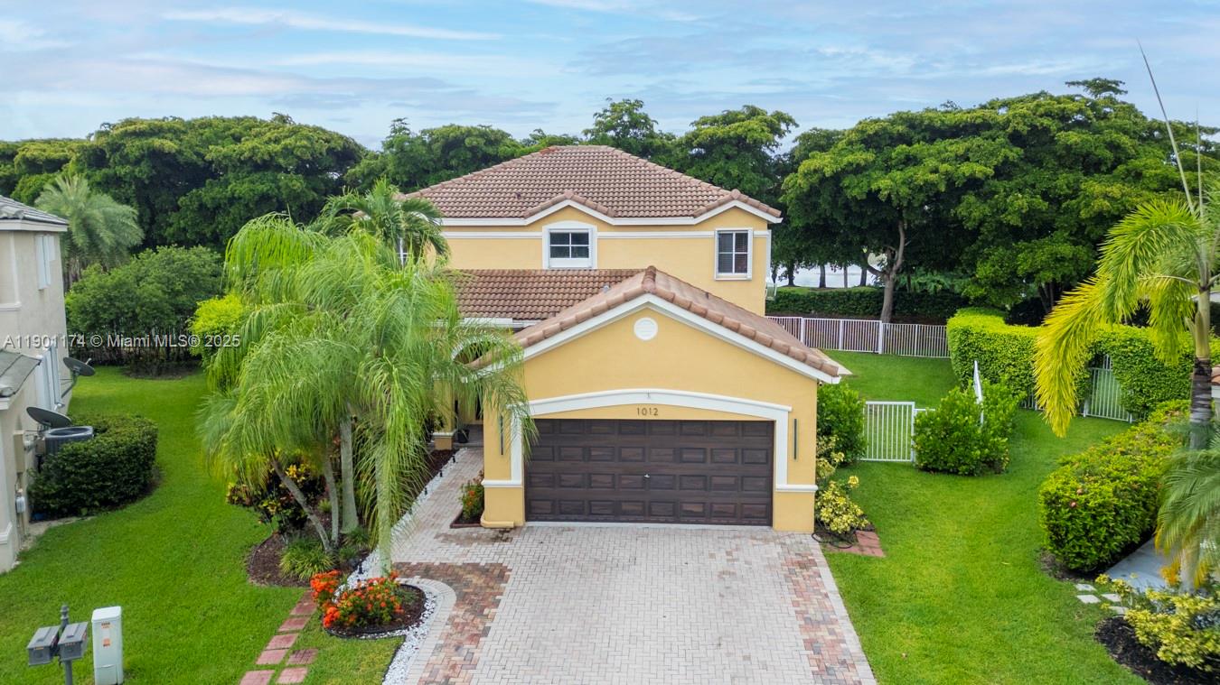 a aerial view of a house with a yard and potted plants